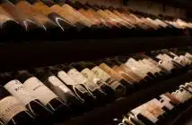 black and white bottles on brown wooden shelf