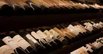 black and white bottles on brown wooden shelf