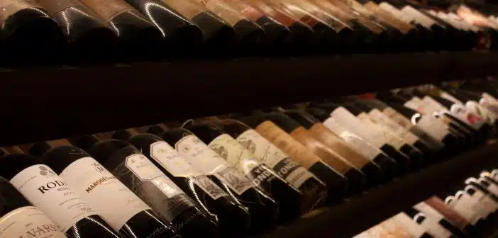 black and white bottles on brown wooden shelf